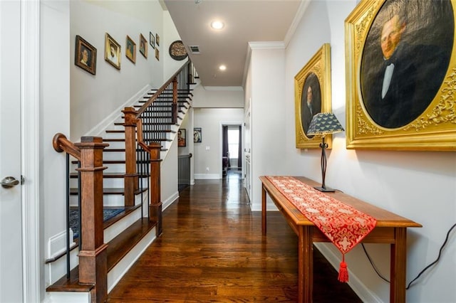 hallway with visible vents, dark wood finished floors, baseboards, ornamental molding, and recessed lighting