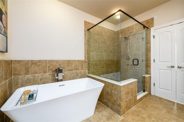 bathroom featuring a sink, a stall shower, and a freestanding bath