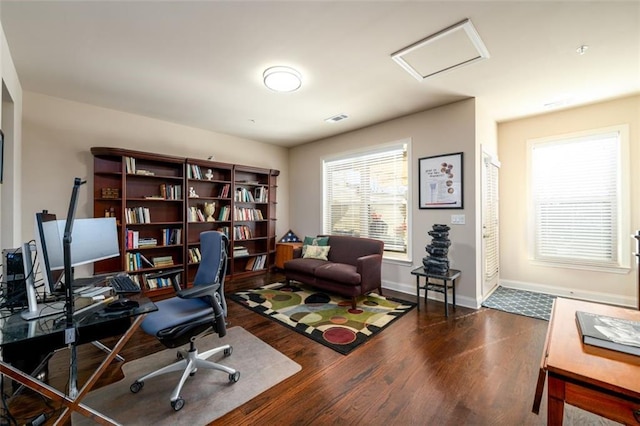 home office featuring dark wood-style floors, attic access, and baseboards