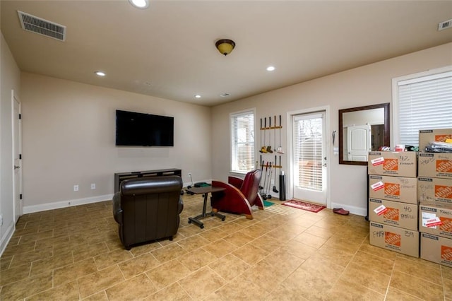 living room with baseboards, visible vents, and recessed lighting