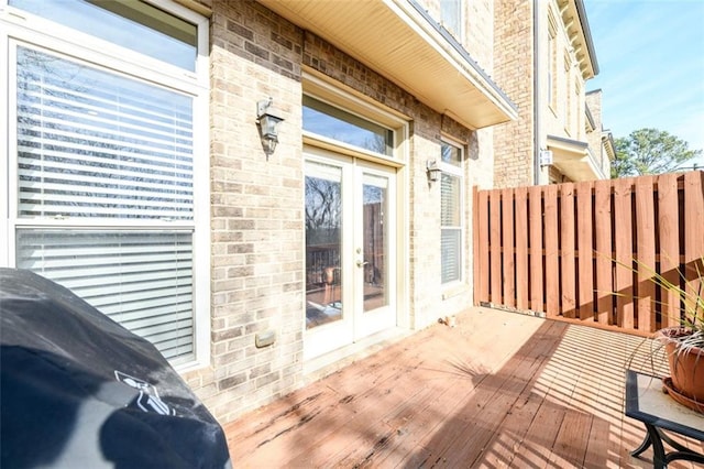 wooden terrace with french doors and area for grilling