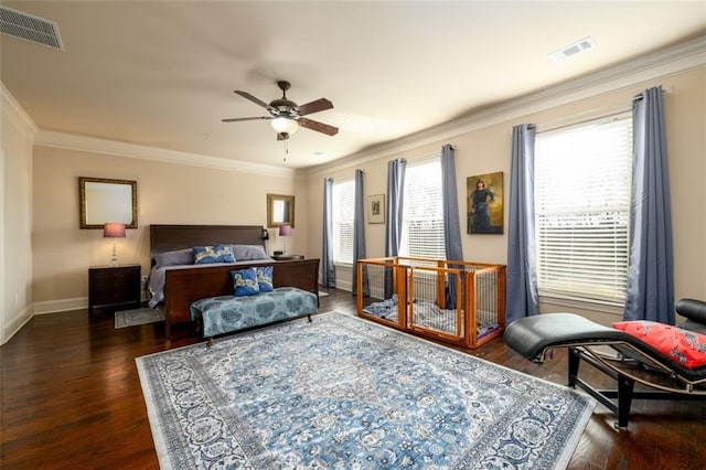 bedroom featuring dark wood-style floors, ornamental molding, and visible vents