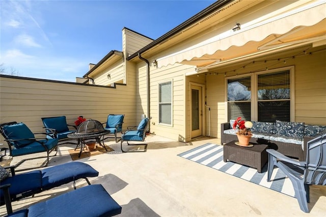 view of patio / terrace featuring an outdoor fire pit