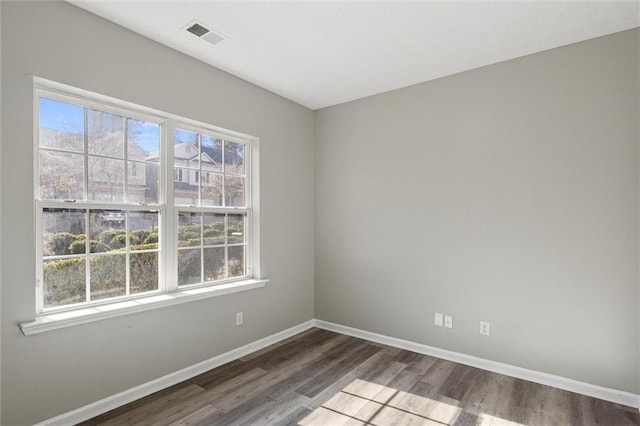 spare room with dark hardwood / wood-style flooring