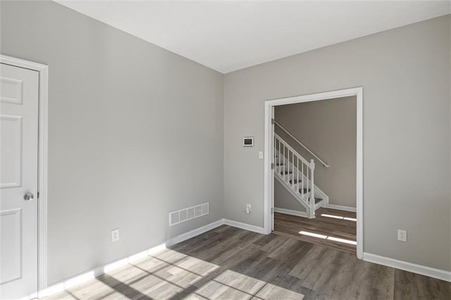 unfurnished room with wood-type flooring