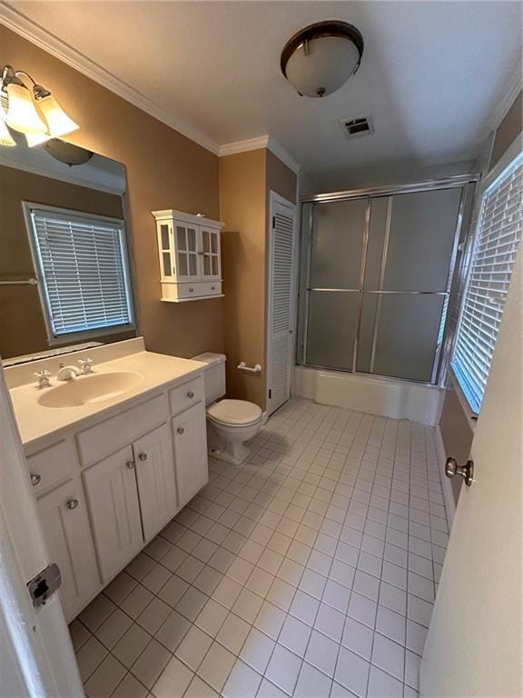 bathroom featuring vanity, tile patterned floors, toilet, ornamental molding, and a shower with door