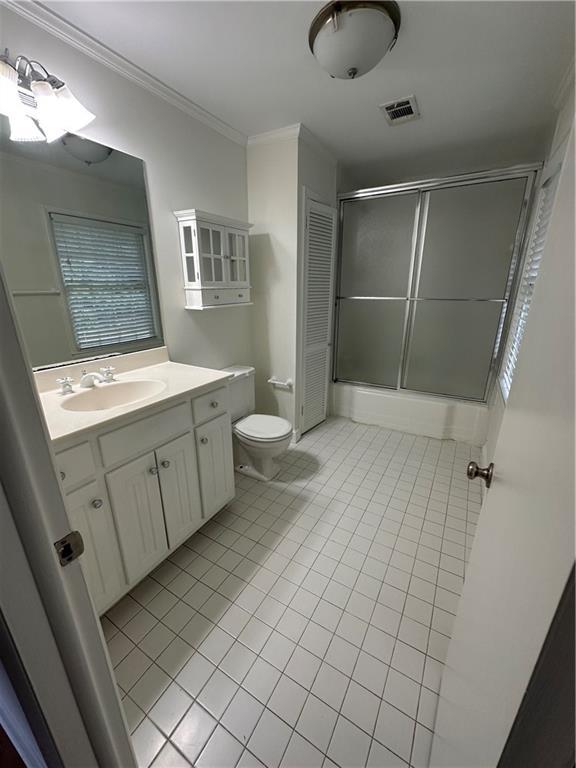 6542 Cherry Tree Ln, Atlanta, GA 30328 - full bath with an enclosed shower, vanity, tile patterned flooring, and crown molding