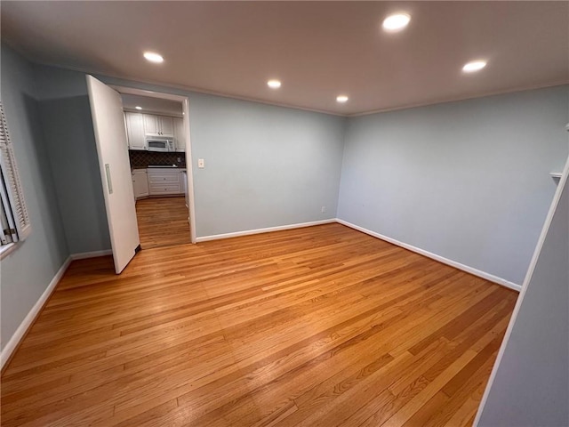 interior space featuring recessed lighting, baseboards, and light wood-style floors