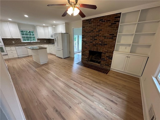 6542 Cherry Tree Ln, Atlanta, GA 30328 - kitchen with white appliances, crown molding, plenty of natural light, ceiling fan, and white cabinets