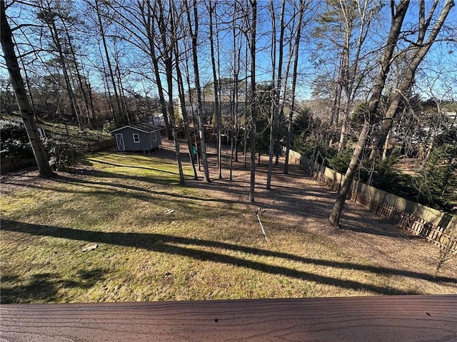 view of yard featuring an outdoor structure and a fenced backyard