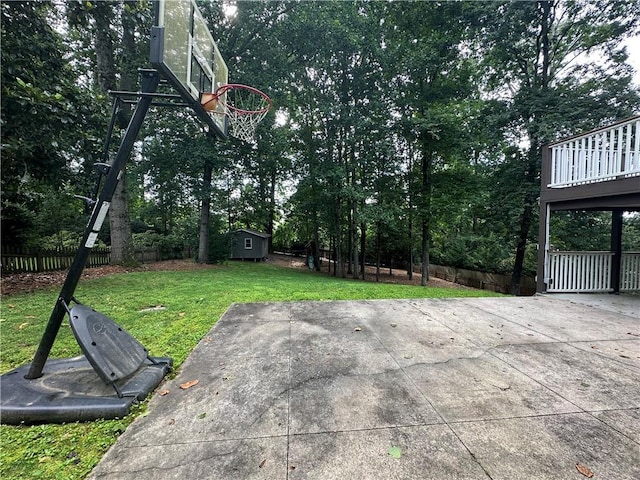 6542 Cherry Tree Ln, Atlanta, GA 30328 - view of patio / terrace with a storage unit, basketball hoop, and view of scattered trees