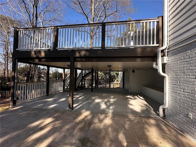 exterior space with stairway, driveway, and a carport