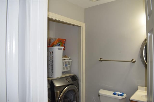 clothes washing area with washer / dryer