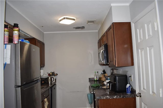 kitchen featuring ornamental molding and appliances with stainless steel finishes