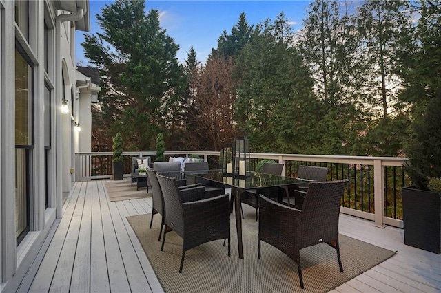 deck at dusk featuring an outdoor hangout area