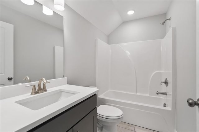 full bathroom with bathtub / shower combination, toilet, tile patterned floors, vaulted ceiling, and vanity