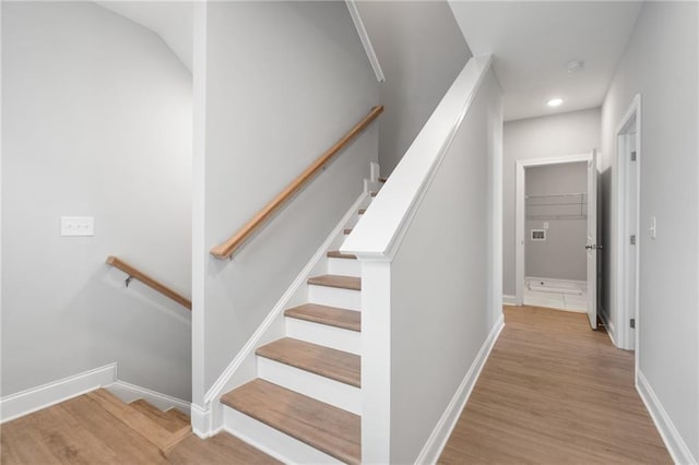 stairway with hardwood / wood-style flooring