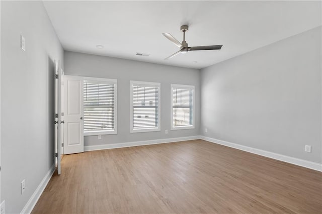 empty room with light hardwood / wood-style flooring and ceiling fan