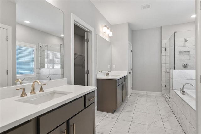 bathroom featuring vanity and separate shower and tub