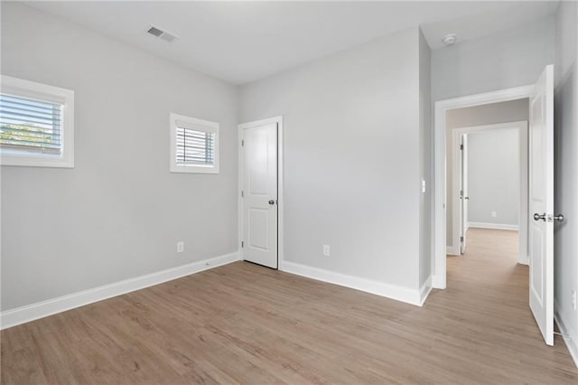 empty room with light hardwood / wood-style floors