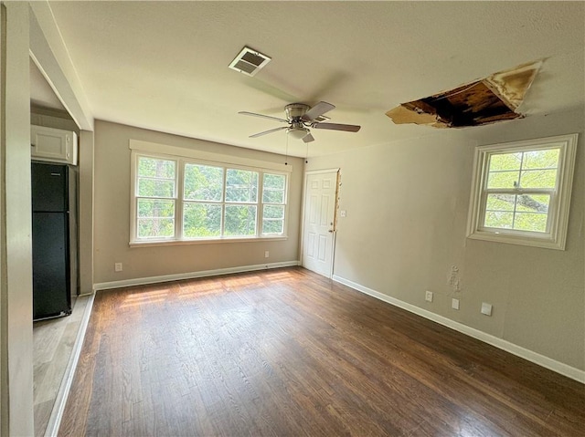 empty room featuring hardwood / wood-style floors and ceiling fan