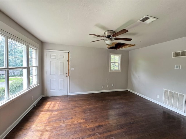 empty room featuring ceiling fan and dark wood-type flooring