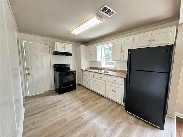 kitchen featuring white cabinetry, light hardwood / wood-style floors, sink, black appliances, and crown molding