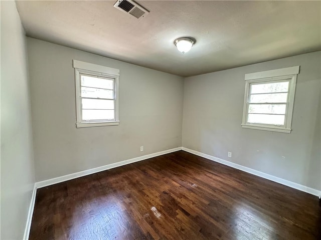 spare room with hardwood / wood-style flooring