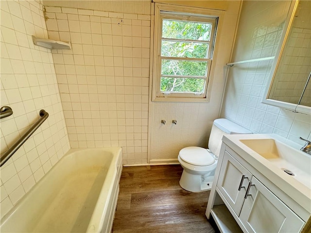 bathroom featuring tile walls, toilet, vanity, and wood-type flooring