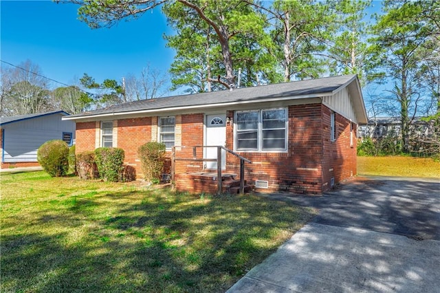 view of front facade with brick siding, crawl space, and a front lawn