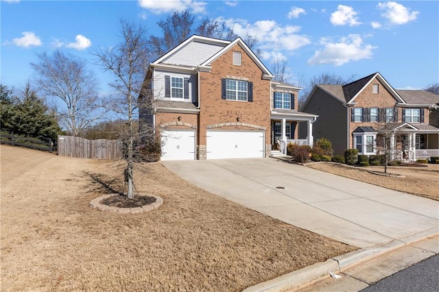 traditional-style house with brick siding, fence, driveway, and an attached garage