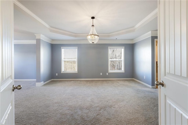 carpeted empty room featuring plenty of natural light, baseboards, and a raised ceiling