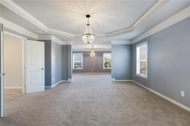 unfurnished room featuring carpet floors, a tray ceiling, crown molding, and baseboards