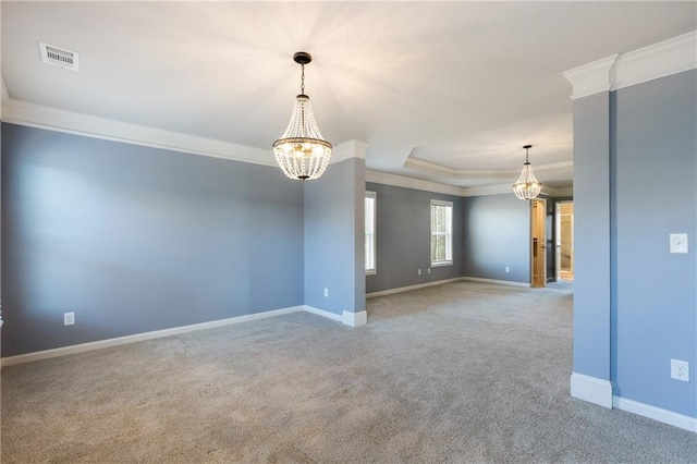 carpeted empty room with visible vents, baseboards, ornamental molding, a tray ceiling, and an inviting chandelier