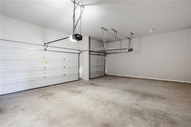 garage featuring a garage door opener and baseboards