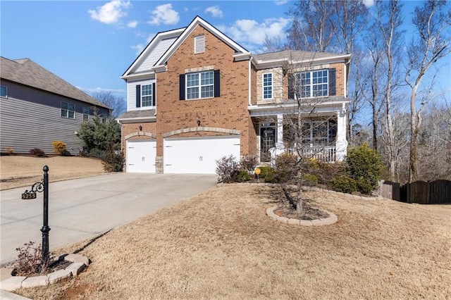 traditional-style house featuring brick siding, driveway, and an attached garage