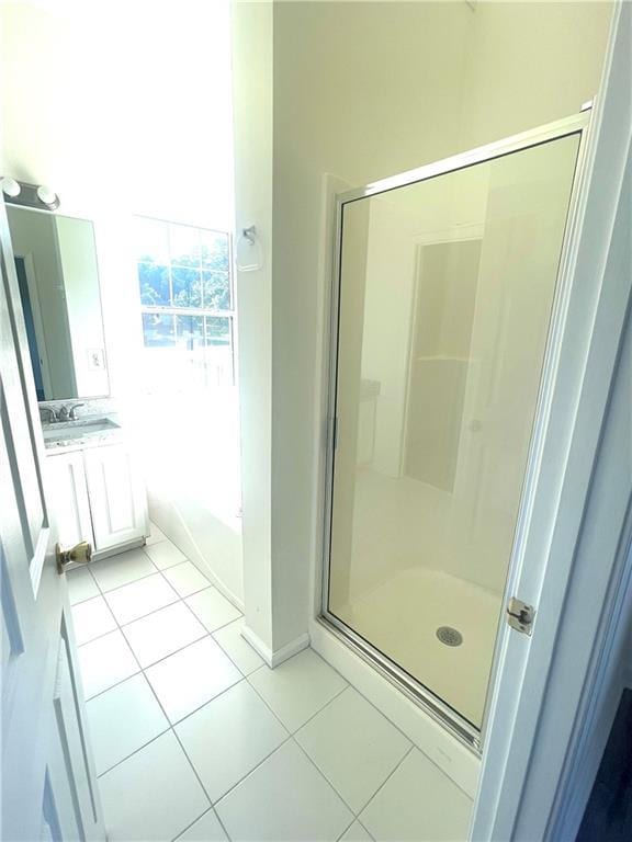 203 Sea Marsh Ct, Fayetteville, GA 30215 - bathroom with vanity, a stall shower, tile patterned floors, a garden tub, and baseboards