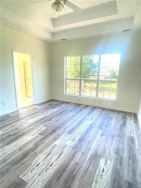 203 Sea Marsh Ct, Fayetteville, GA 30215 - empty room featuring a raised ceiling, wood finished floors, a ceiling fan, and baseboards