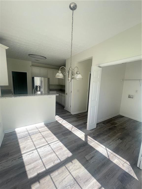 203 Sea Marsh Ct, Fayetteville, GA 30215 - unfurnished dining area with baseboards, dark wood-style flooring, and a chandelier
