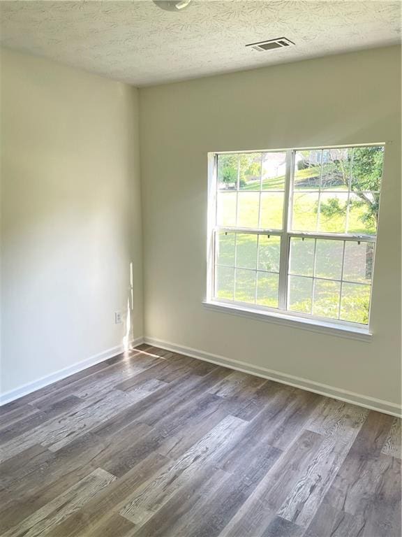 203 Sea Marsh Ct, Fayetteville, GA 30215 - unfurnished room featuring dark wood-type flooring, baseboards, and a textured ceiling