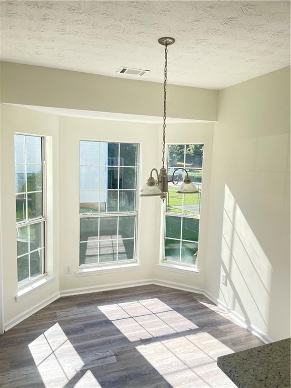 203 Sea Marsh Ct, Fayetteville, GA 30215 - unfurnished dining area with wood finished floors, baseboards, healthy amount of natural light, and a textured ceiling