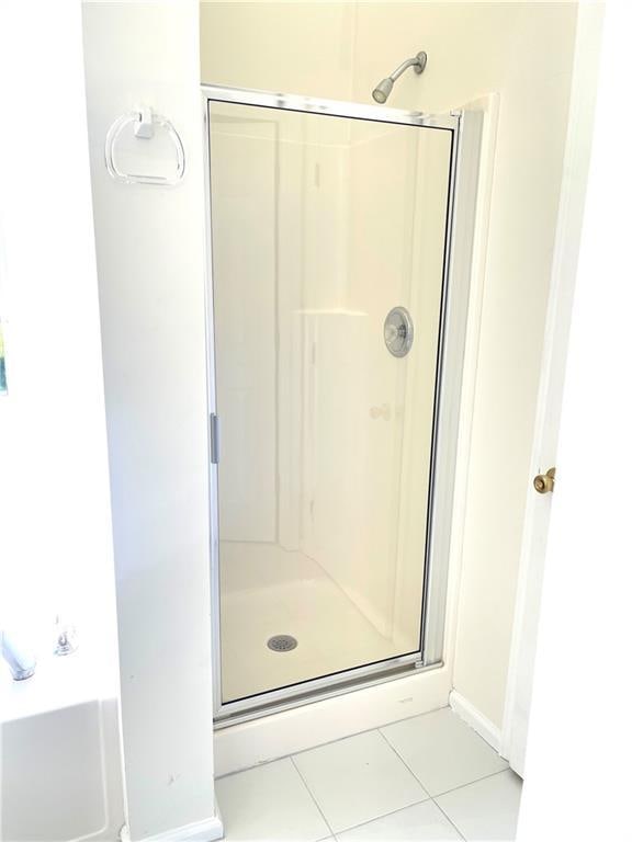 203 Sea Marsh Ct, Fayetteville, GA 30215 - bathroom with a shower stall, tile patterned floors, and baseboards