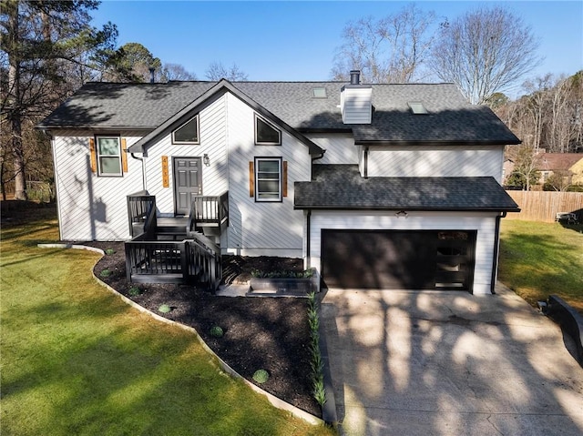 view of front of house with a garage and a front lawn