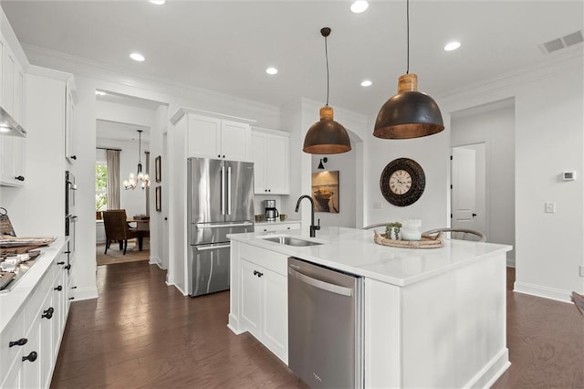635 Opera Ln, Alpharetta, GA 30009 - kitchen with stainless steel appliances, light countertops, ornamental molding, dark wood-style floors, and a chandelier