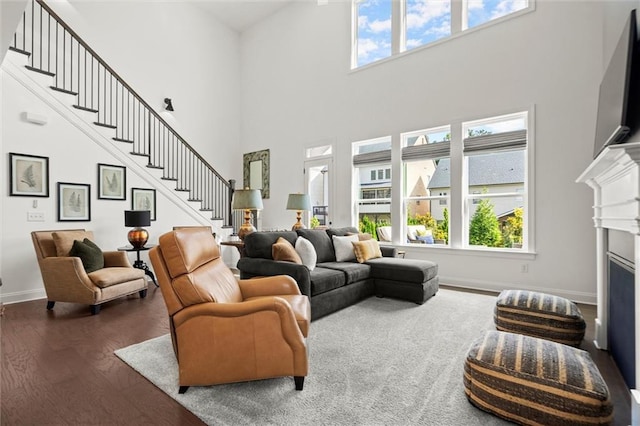635 Opera Ln, Alpharetta, GA 30009 - living area with a high ceiling, stairway, plenty of natural light, wood finished floors, and a fireplace