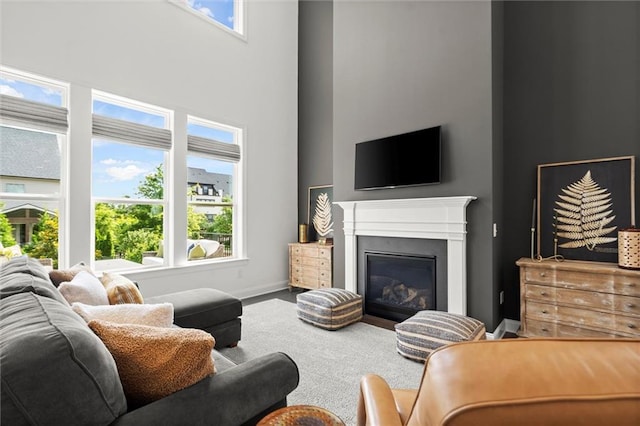 635 Opera Ln, Alpharetta, GA 30009 - living room with a high ceiling, a glass covered fireplace, and carpet floors