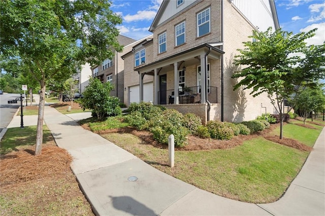 635 Opera Ln, Alpharetta, GA 30009 - view of front of house featuring brick siding, a porch, board and batten siding, and a front yard