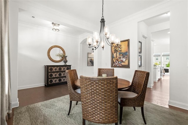 635 Opera Ln, Alpharetta, GA 30009 - dining space featuring wood finished floors, a chandelier, ornamental molding, and arched walkways