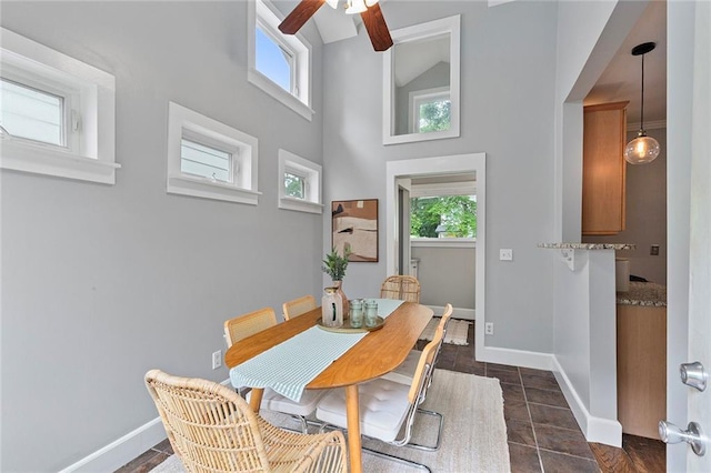 628 Home Ave SE, Atlanta, GA 30312 - dining space with ceiling fan, baseboards, a high ceiling, and dark tile patterned flooring