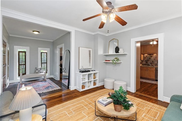 628 Home Ave SE, Atlanta, GA 30312 - living area with wood finished floors, ceiling fan, baseboards, and crown molding